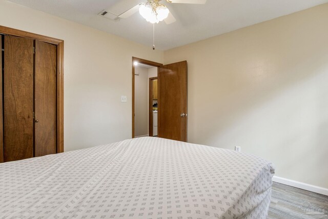 bedroom with hardwood / wood-style flooring, a closet, and ceiling fan