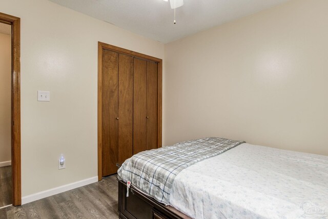 bedroom featuring a closet, ceiling fan, and dark hardwood / wood-style flooring