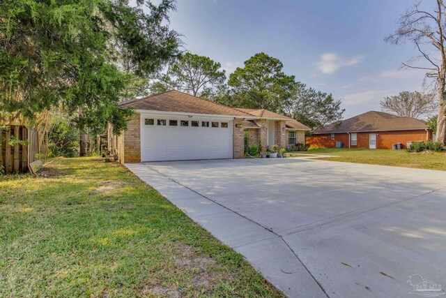 ranch-style house featuring a front lawn and a garage