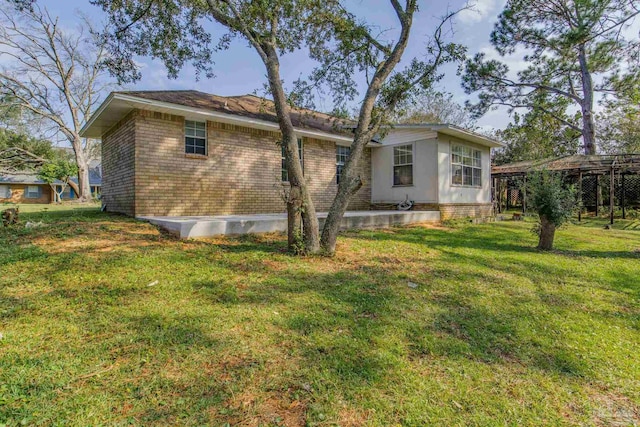 rear view of property with a yard