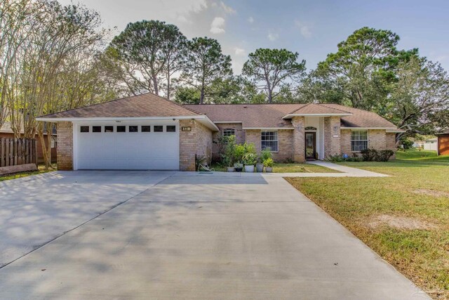 ranch-style house featuring a front yard and a garage