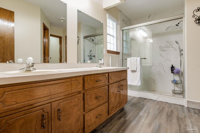 bathroom with vanity, wood-type flooring, and a shower with shower door