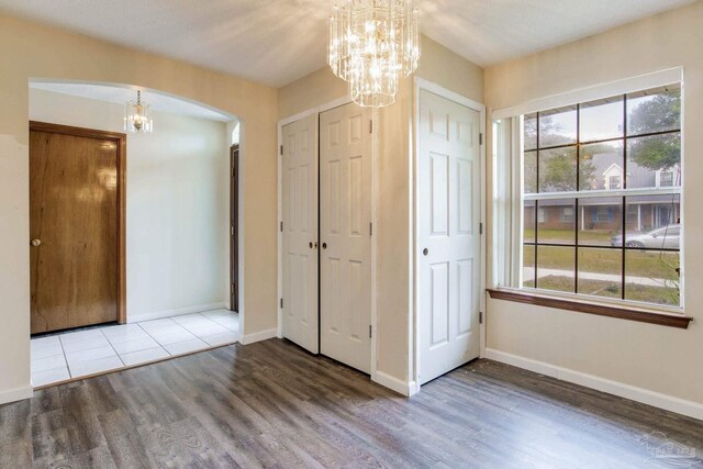 unfurnished bedroom featuring a textured ceiling and hardwood / wood-style floors