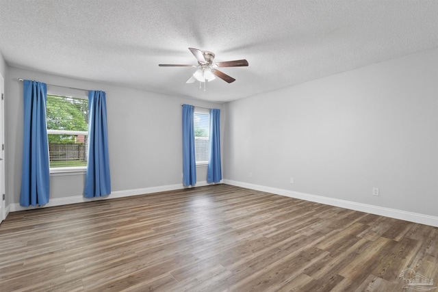 5732 Dove Dr, Pace, FL 32571 - spare room with a textured ceiling, wood finished floors, ceiling fan, and baseboards
