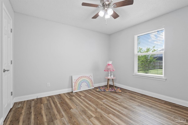 5732 Dove Dr, Pace, FL 32571 - rec room with wood finished floors, baseboards, a ceiling fan, and a textured ceiling