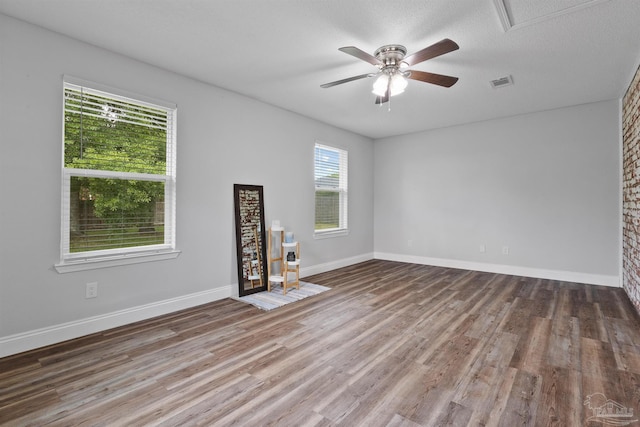 5732 Dove Dr, Pace, FL 32571 - empty room with wood finished floors, ceiling fan, and baseboards