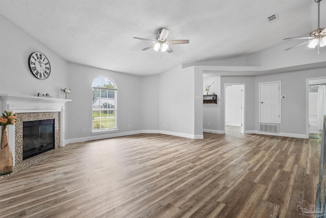 5732 Dove Dr, Pace, FL 32571 - unfurnished living room featuring ceiling fan, a fireplace, wood finished floors, a textured ceiling, and baseboards