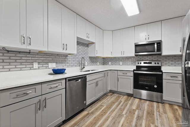 5732 Dove Dr, Pace, FL 32571 - kitchen with appliances with stainless steel finishes, a sink, gray cabinets, and light countertops