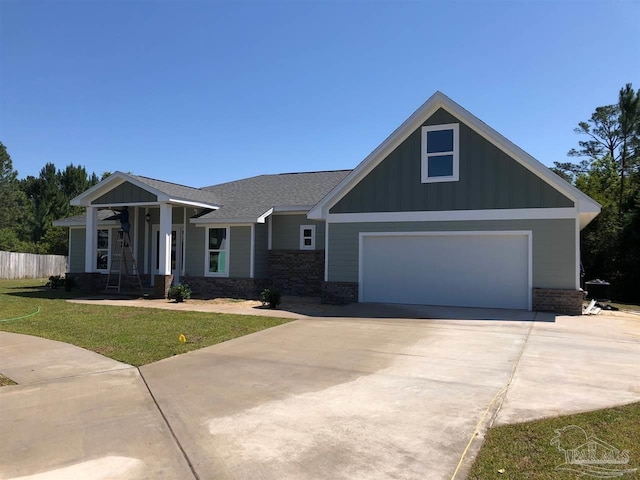 1712 Windpointe Cv, Gulf Breeze, FL 32563 - craftsman-style house featuring board and batten siding, concrete driveway, brick siding, an attached garage, and a shingled roof
