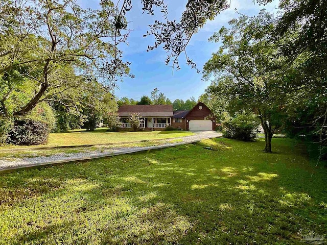 3648 Wiggins Ln, Cantonment, FL 32533 - view of front of house featuring a front lawn, a garage, and driveway