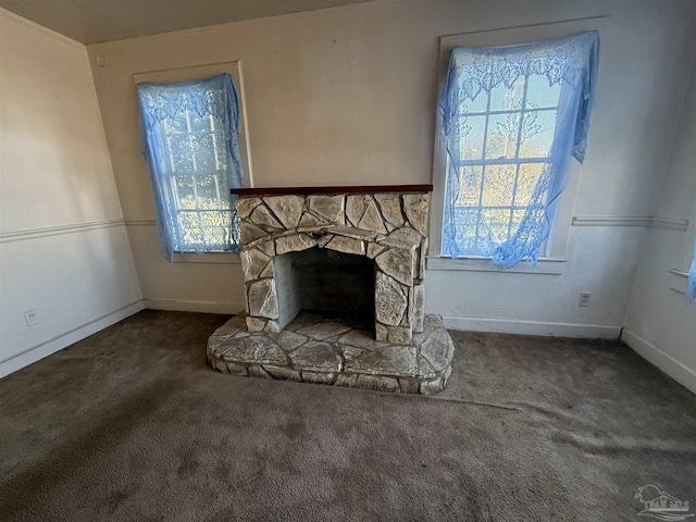 unfurnished living room with carpet floors, a wealth of natural light, and a fireplace