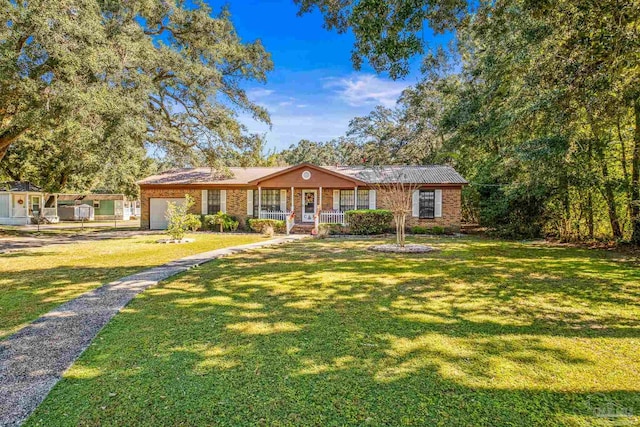 ranch-style house featuring a front lawn and covered porch