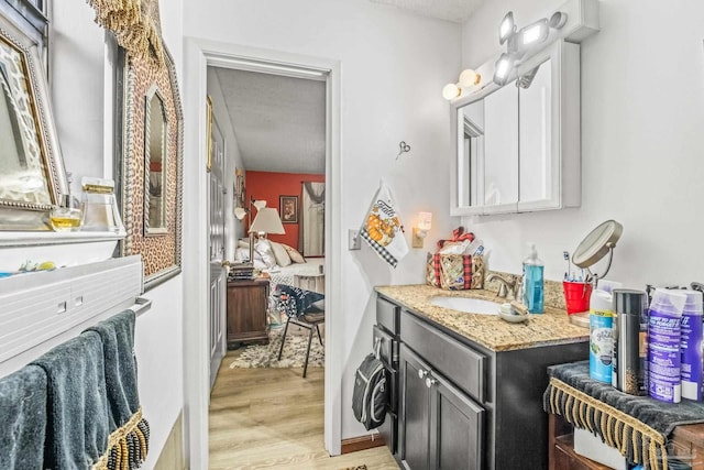 bathroom featuring a textured ceiling, hardwood / wood-style flooring, and vanity