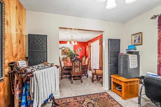 office area with a textured ceiling, a chandelier, and carpet floors