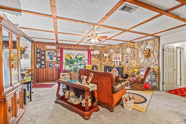 living room with ceiling fan, coffered ceiling, and carpet floors