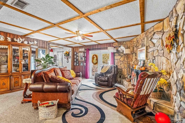 carpeted living room with a textured ceiling, coffered ceiling, ceiling fan, and french doors