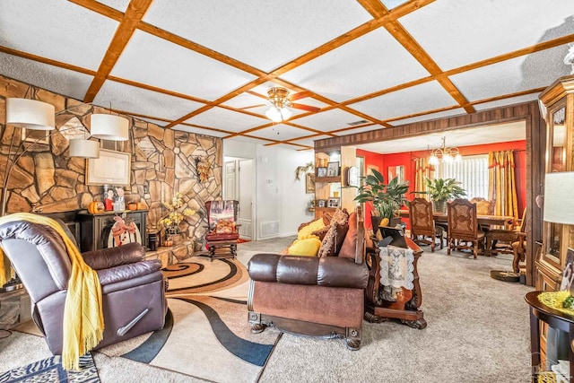 living room featuring coffered ceiling, light colored carpet, and ceiling fan with notable chandelier