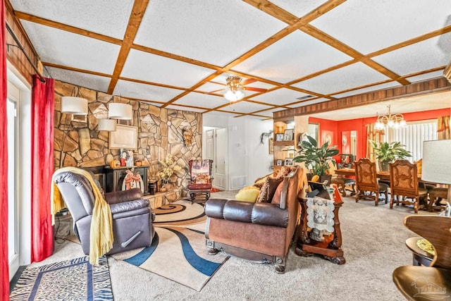 carpeted living room featuring coffered ceiling and ceiling fan with notable chandelier