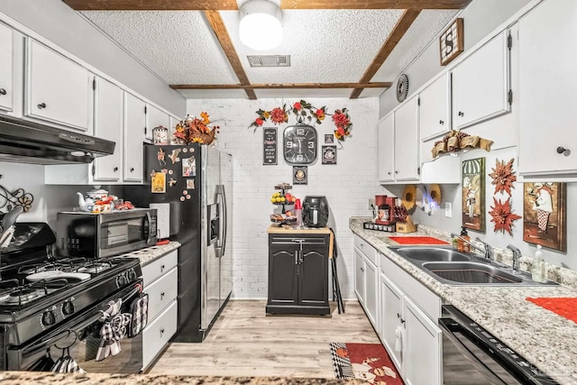 kitchen with light hardwood / wood-style flooring, white cabinetry, appliances with stainless steel finishes, and sink