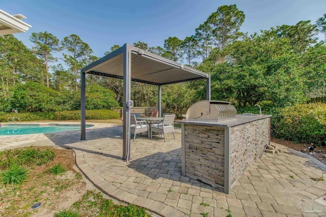 view of patio featuring outdoor dining space, area for grilling, and an outdoor pool