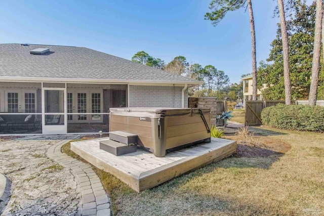 exterior space featuring french doors, fence, and a hot tub