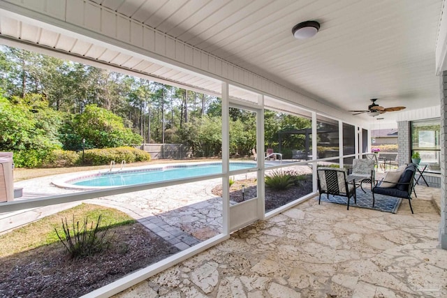 sunroom featuring ceiling fan