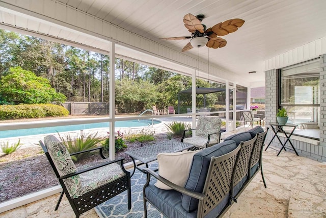 sunroom featuring a ceiling fan