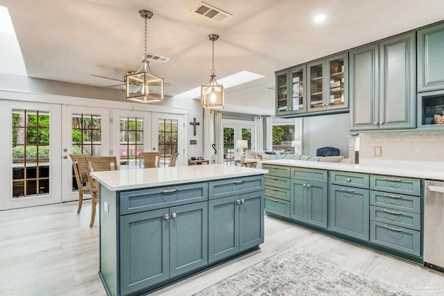 kitchen featuring french doors, stainless steel dishwasher, visible vents, and light countertops