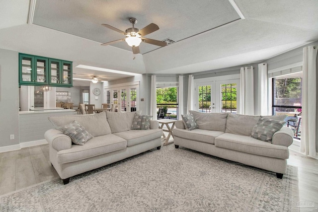 living area featuring visible vents, a ceiling fan, wood finished floors, french doors, and baseboards