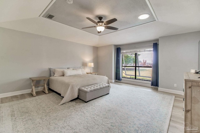 bedroom with visible vents, light wood-style flooring, and baseboards