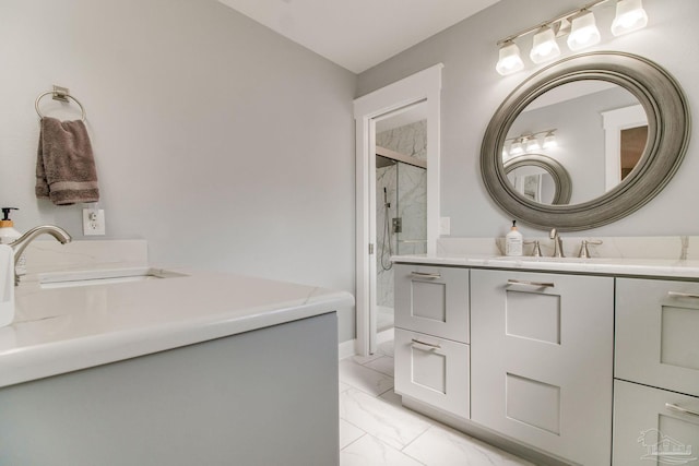 full bath with marble finish floor, a shower stall, and vanity