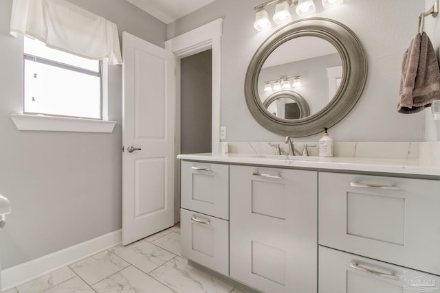 bathroom featuring baseboards, marble finish floor, and vanity