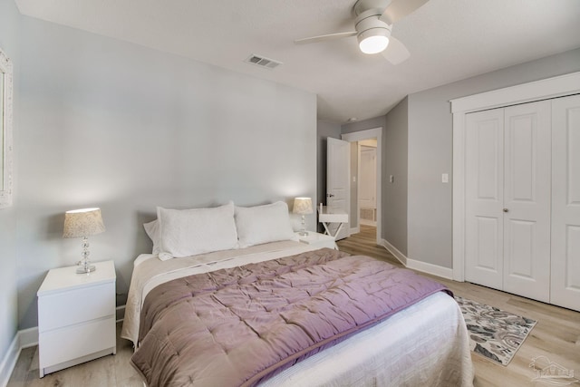 bedroom featuring a ceiling fan, visible vents, baseboards, a closet, and light wood-type flooring