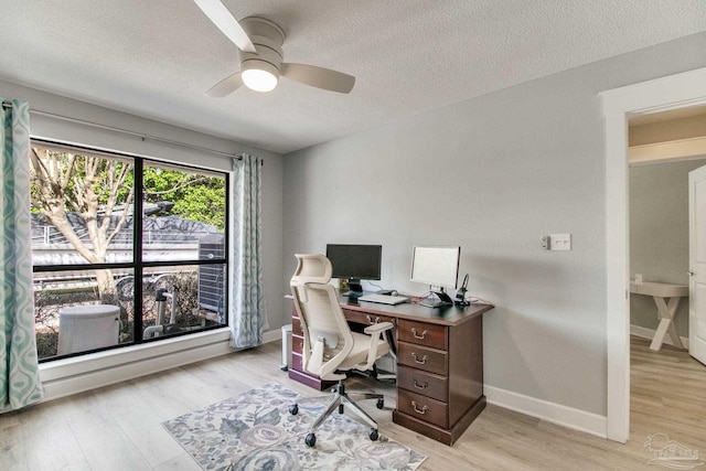 office space featuring ceiling fan, baseboards, and light wood-style floors