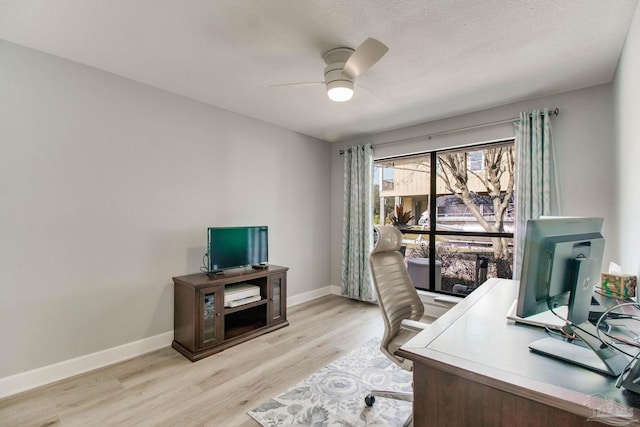 office with light wood-type flooring, baseboards, a textured ceiling, and a ceiling fan