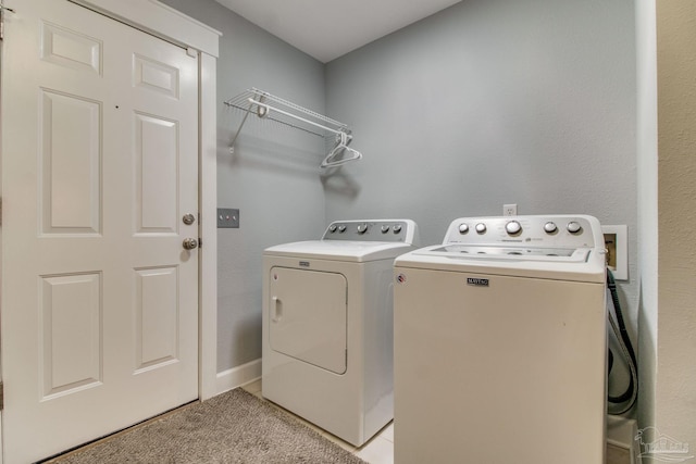 clothes washing area with light tile patterned flooring, laundry area, and separate washer and dryer