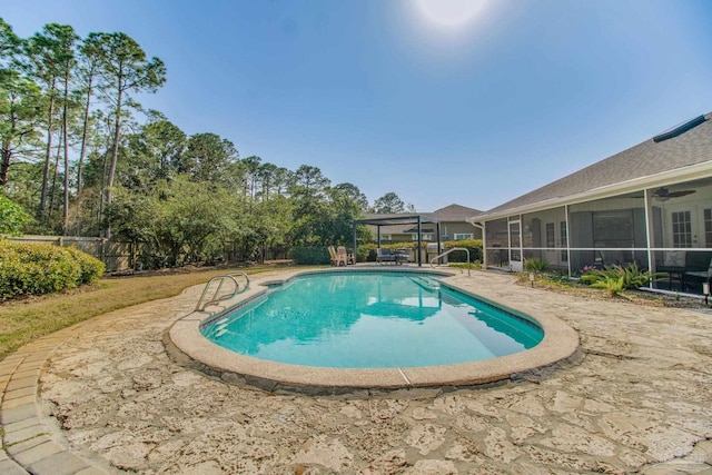 view of pool featuring a patio area, a fenced in pool, fence, and a sunroom