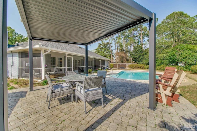 outdoor pool with outdoor dining space, a patio, fence, and a sunroom