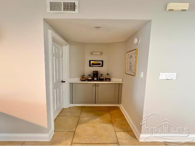 hallway featuring light tile patterned floors