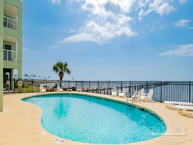 view of pool featuring a water view