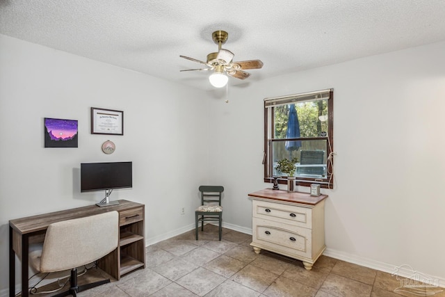 office area featuring ceiling fan, light tile patterned flooring, and a textured ceiling