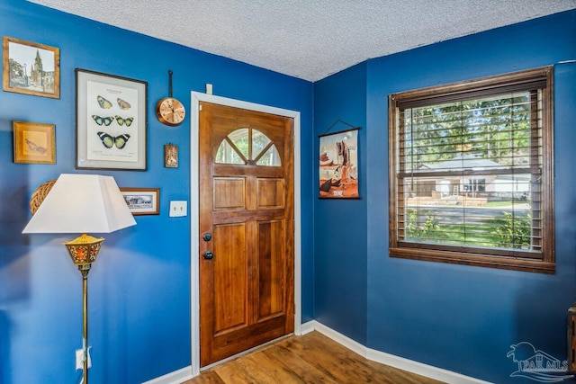 entryway featuring hardwood / wood-style floors and a textured ceiling