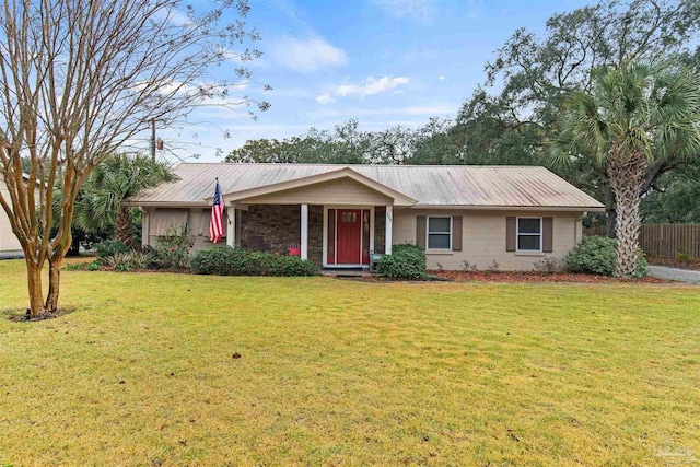 ranch-style house featuring a front yard, fence, and metal roof