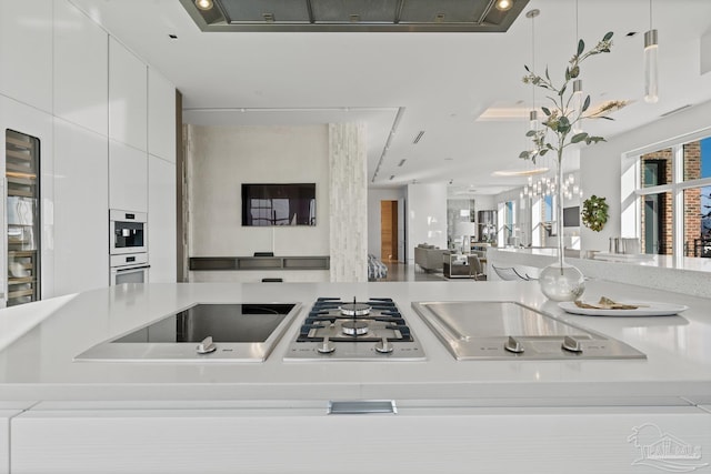 kitchen with white cabinetry and decorative light fixtures