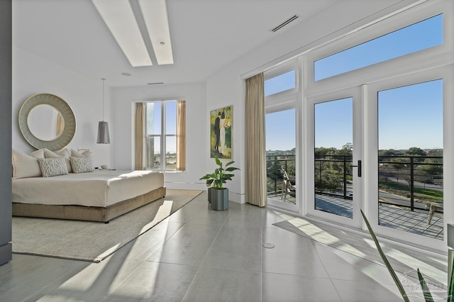 tiled bedroom with multiple windows and access to outside