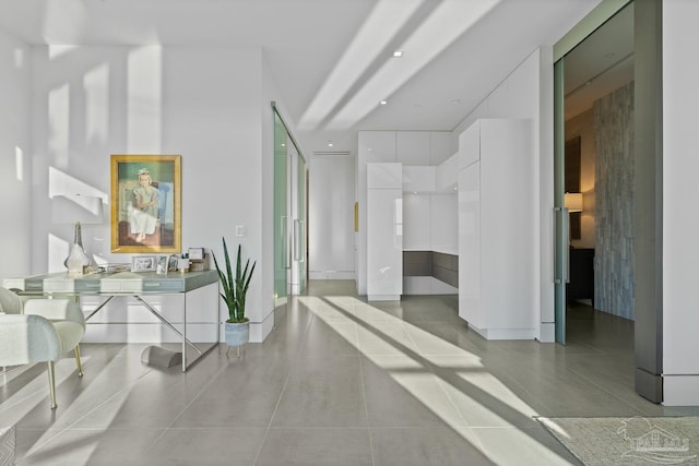 hall featuring light tile patterned floors