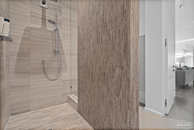 bathroom featuring tiled shower and tile patterned flooring