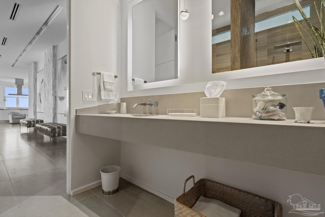 bathroom featuring vanity, tile patterned floors, and a shower