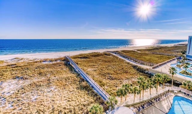 birds eye view of property with a water view and a beach view