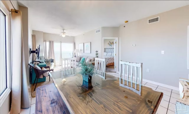 dining room featuring light tile patterned floors, visible vents, and baseboards